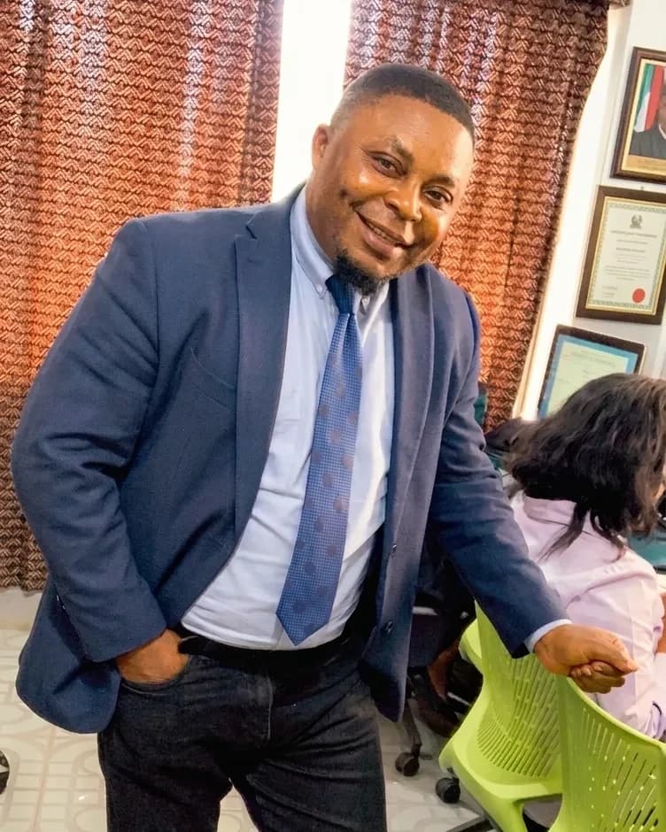 Mohamed Sheriff wearing a blue suit in a professional office setting